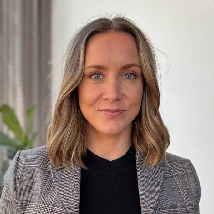 A professional woman standing in a bright office space