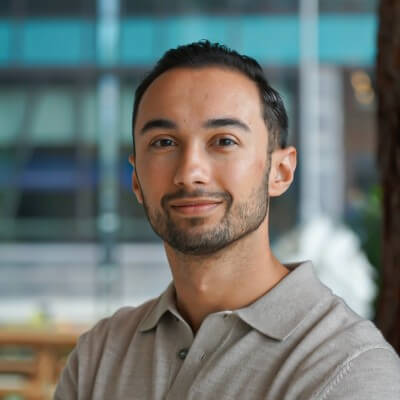 Portrait of a smiling man in a grey polo shirt, suitable for consultancy or CRM-related content.