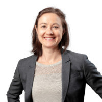 Professional woman smiling confidently, showcasing expertise in CRM solutions for various industries.