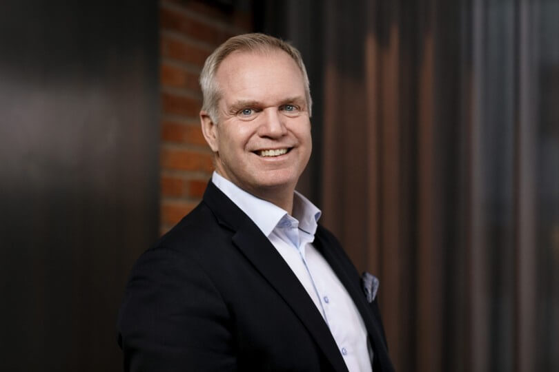 Professional business consultant smiling in office attire.